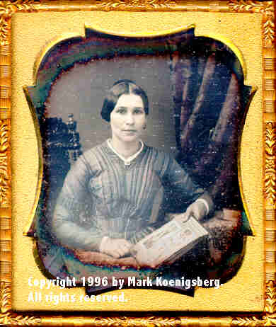 Sixth-plate daguerreotype of Woman with Album in Lap by Broadbent